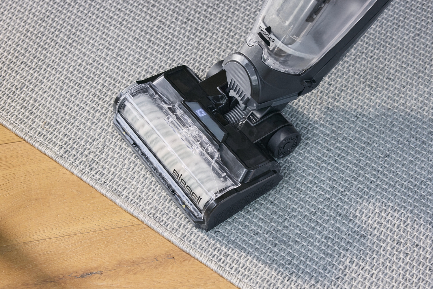 BISSELL CrossWave HydroSteam powered roller cleaning at the edge of an area rug and hard floor