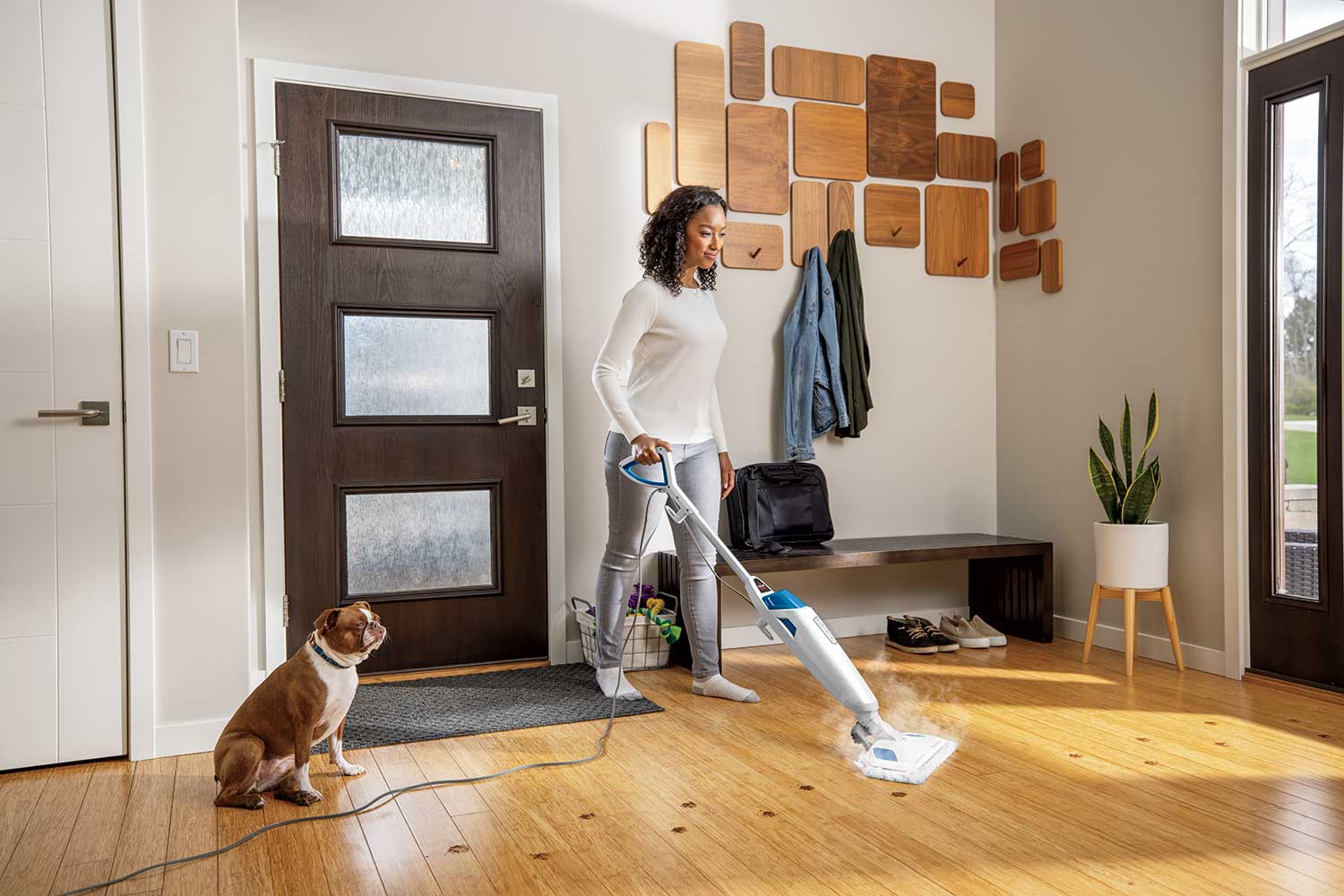 White 1940A floor mop shown on a sealed-looking hard floor with person and dog.